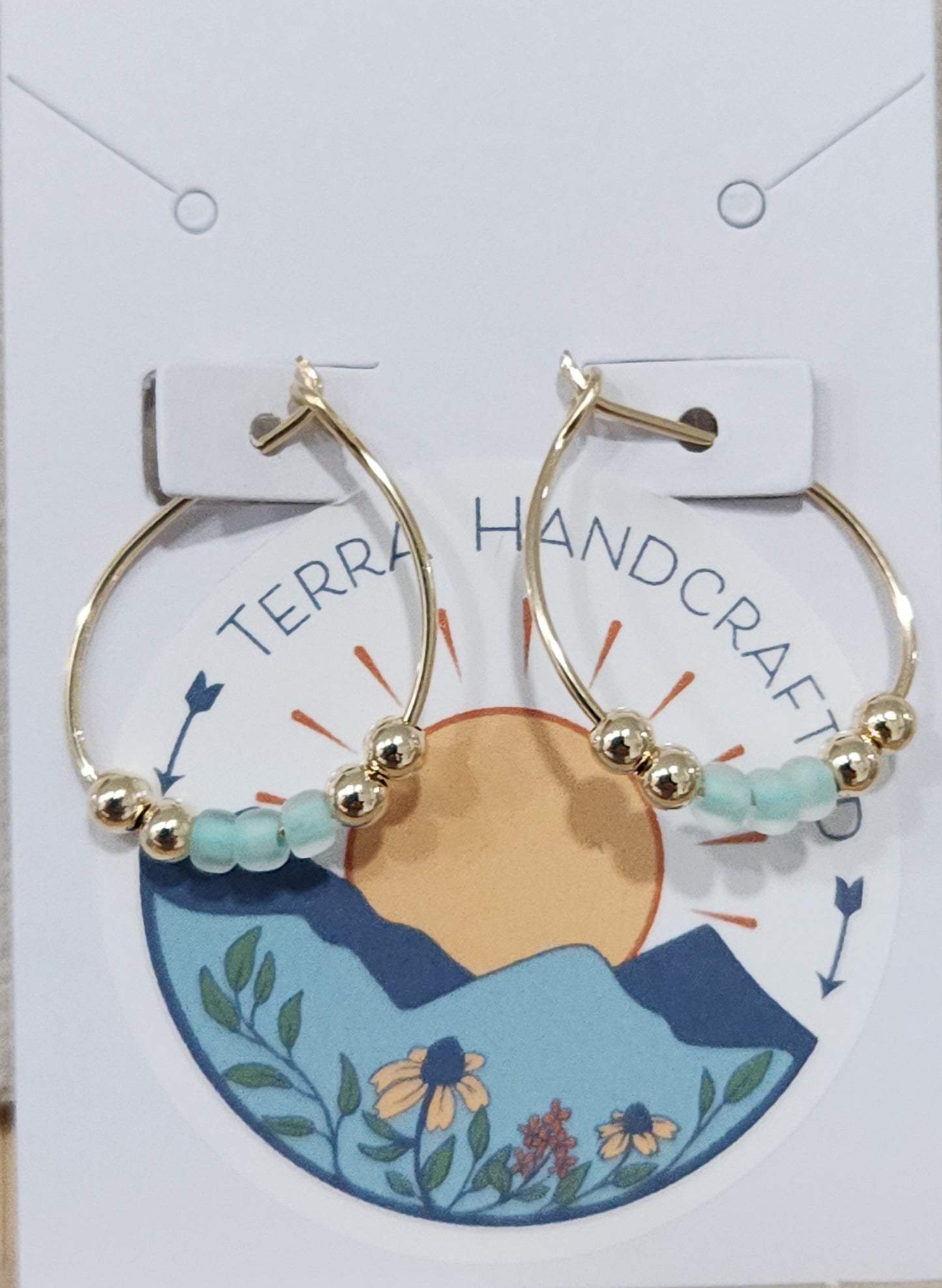 Gold-filled aqua hoop earrings shown in an alternate display highlighting the teardrop design
