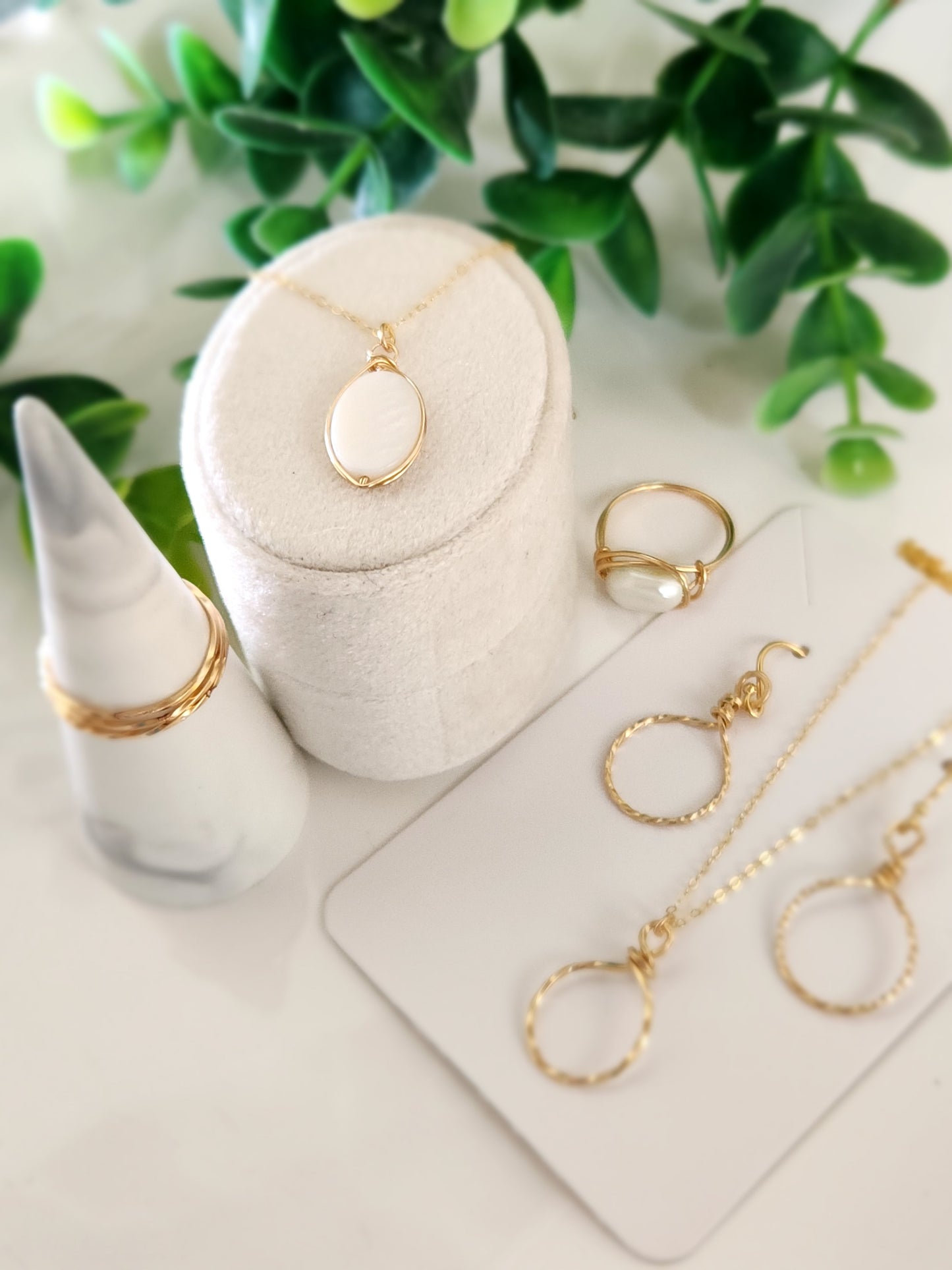 Handcrafted gold-filled necklace styled with minimalist jewelry and natural accents