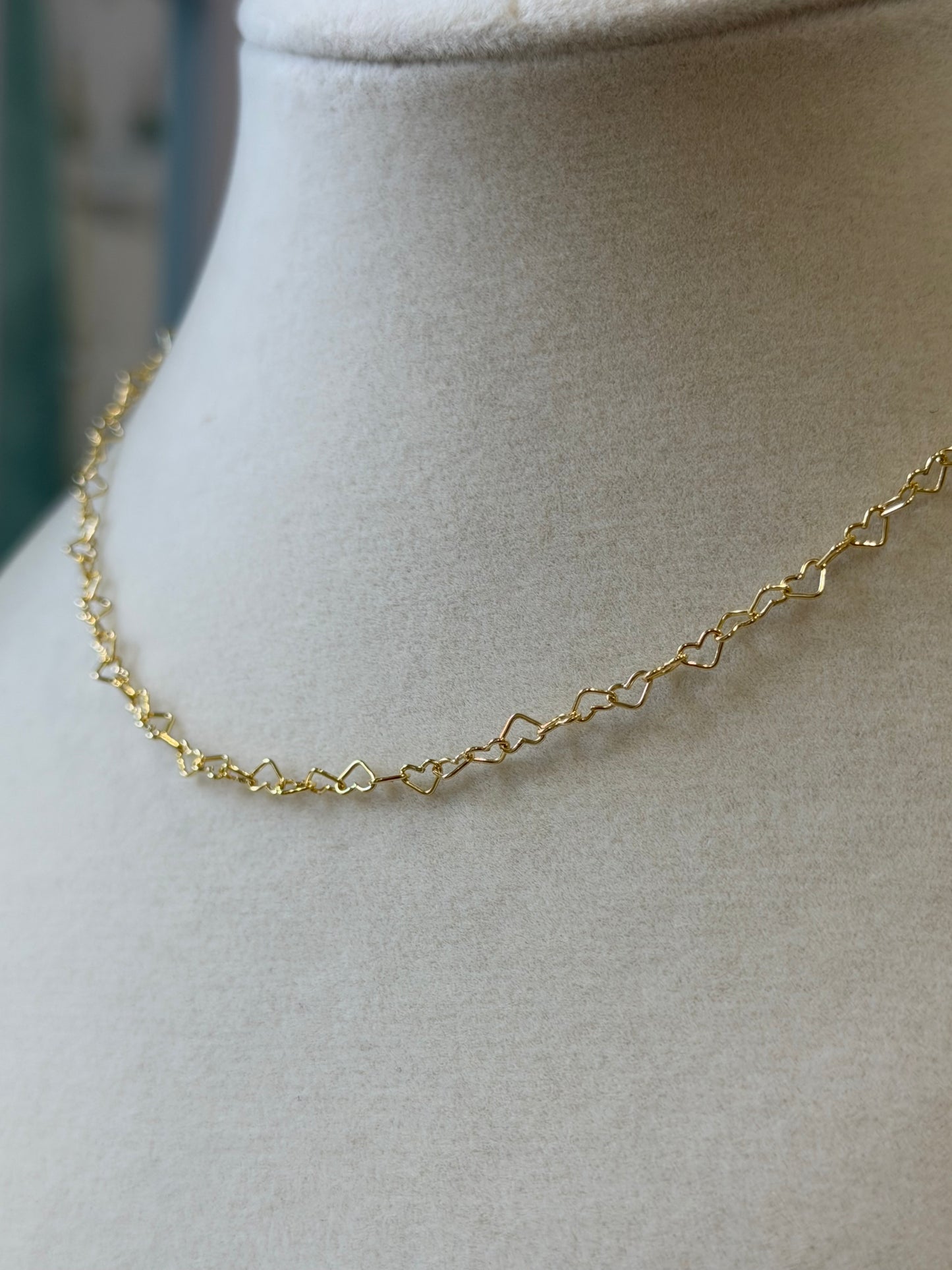 14k gold-filled heart link necklace displayed on a jewelry bust