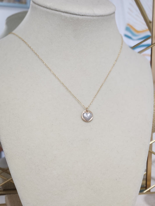 14k gold-filled necklace featuring a sterling silver heart charm displayed on a jewelry bust