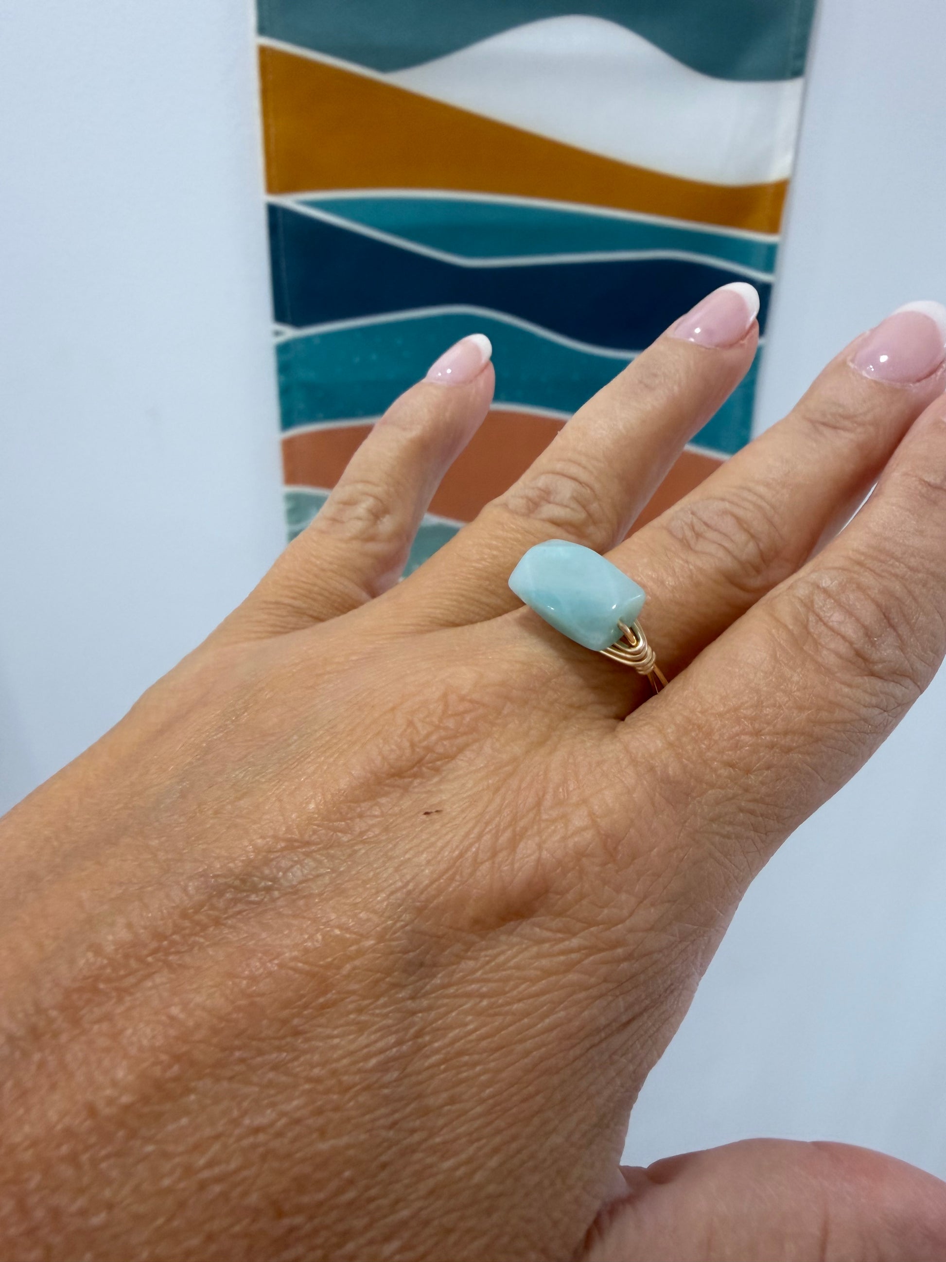 Handcrafted amazonite ring with gold-filled wire shown in a coastal-inspired setting