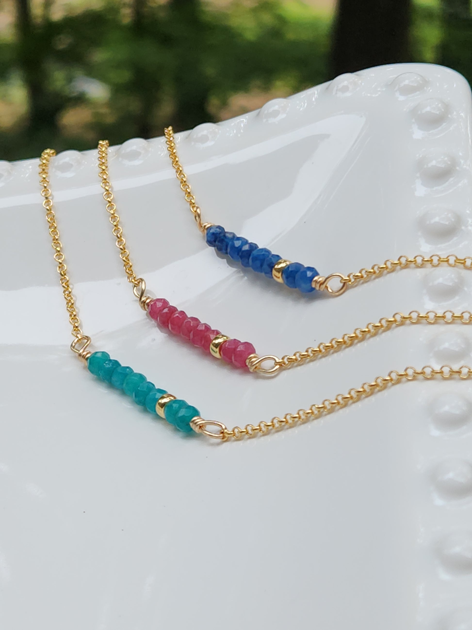 14k gold-filled beaded gemstone necklace featuring sapphire, pink ruby, and blue apatite stones