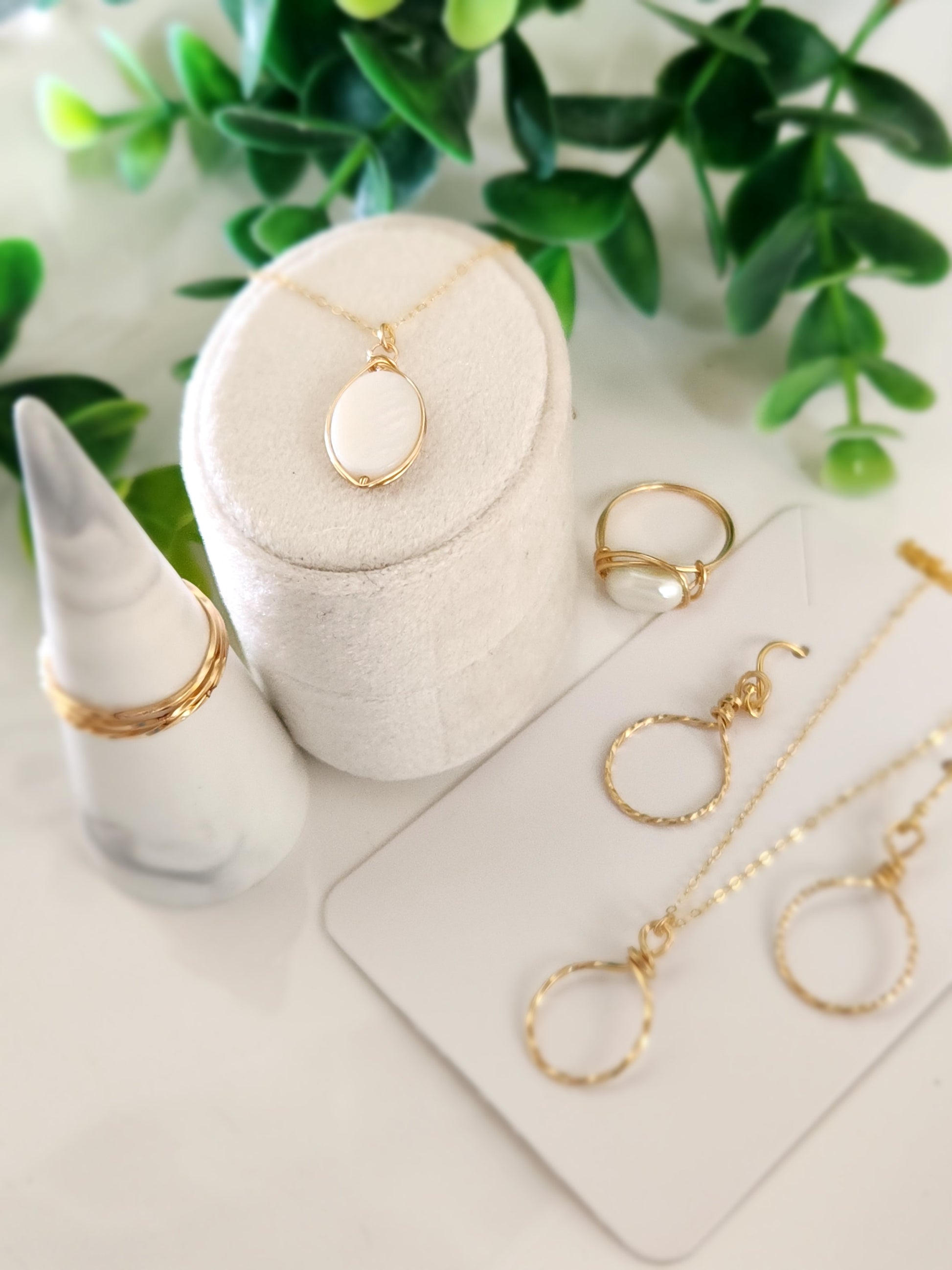 Handcrafted gold-filled necklace styled with minimalist jewelry and natural accents