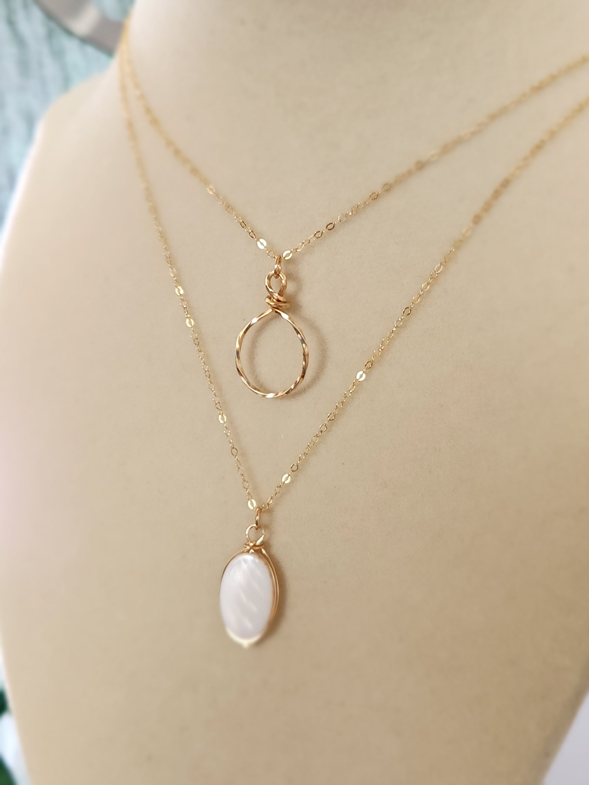 Gold-filled hammered circle necklace shown worn on a mannequin bust