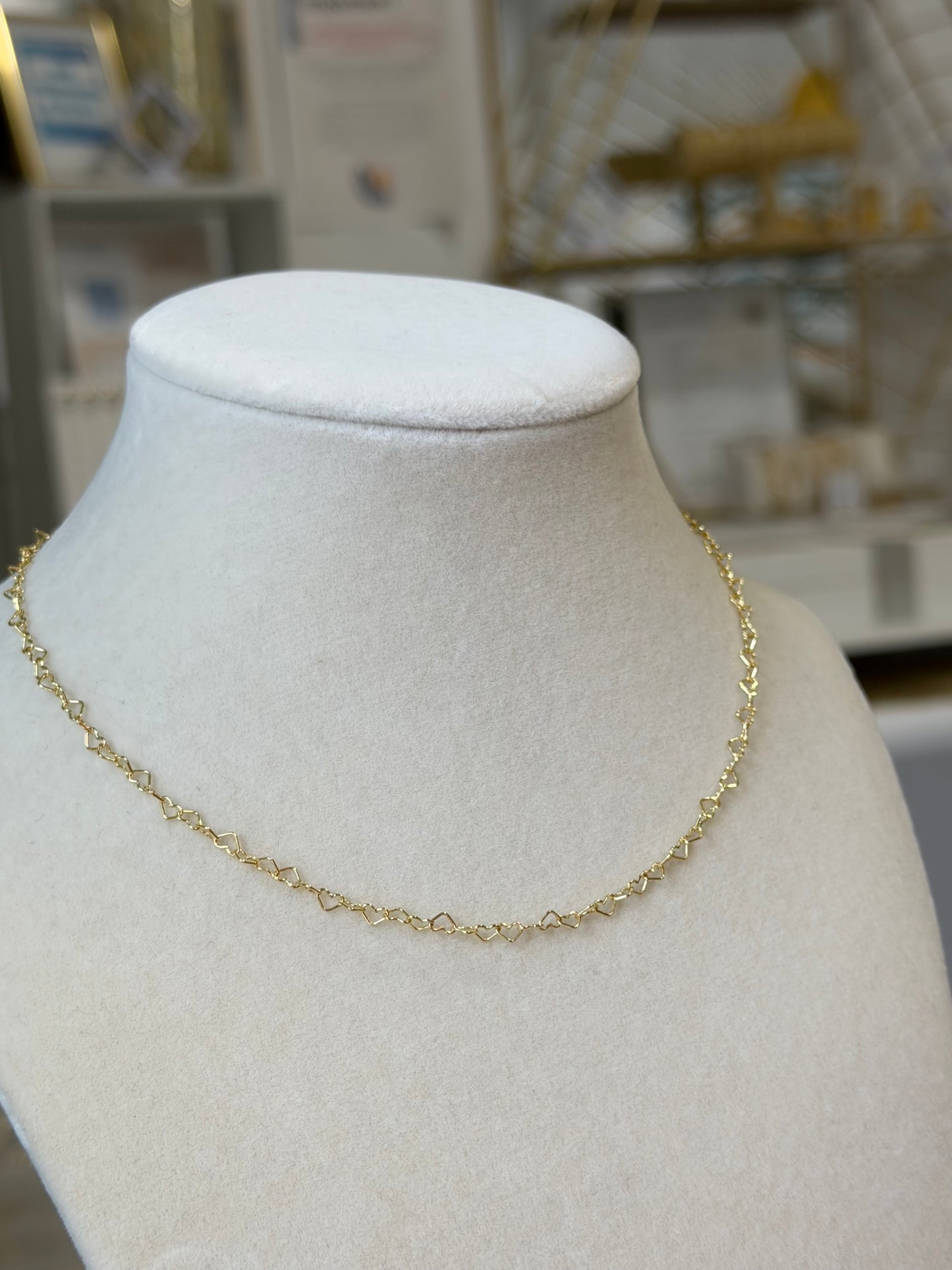 Close-up view of 14k gold-filled heart link chain necklace