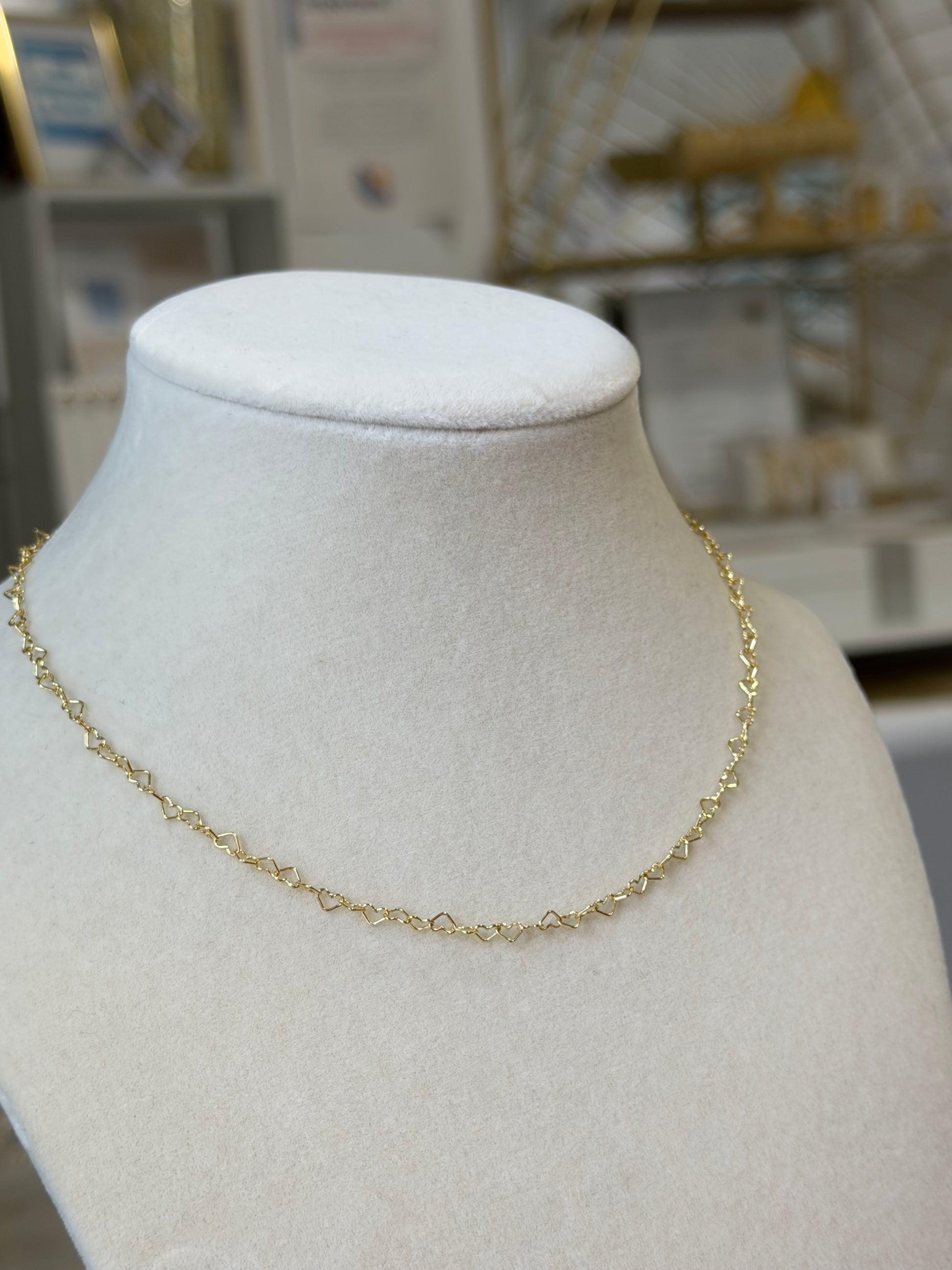 Close-up view of 14k gold-filled heart link chain necklace