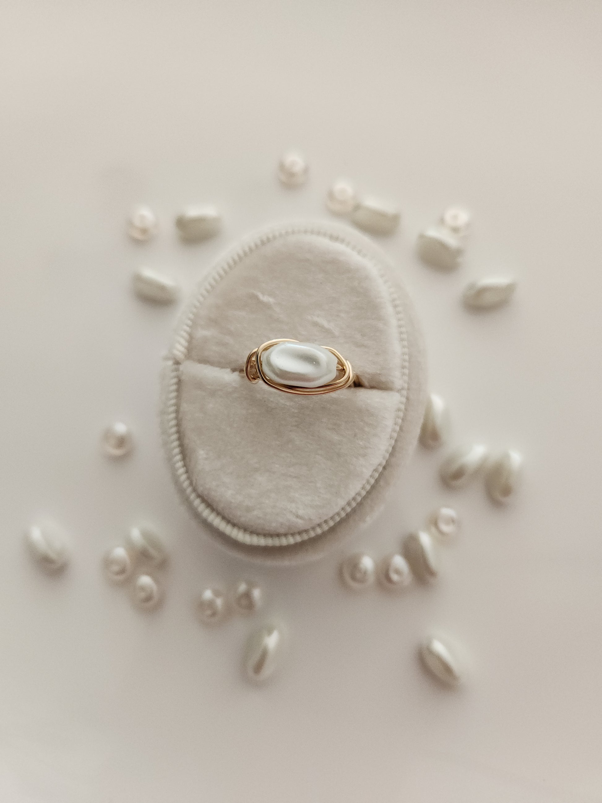 Oblong freshwater pearl ring handcrafted with 14k gold-filled wire displayed on ring stand