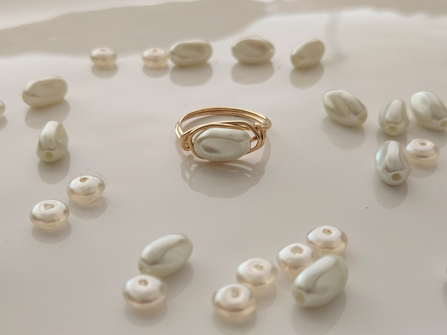 Lifestyle image of oblong freshwater pearl ring handcrafted with 14k gold-filled wire