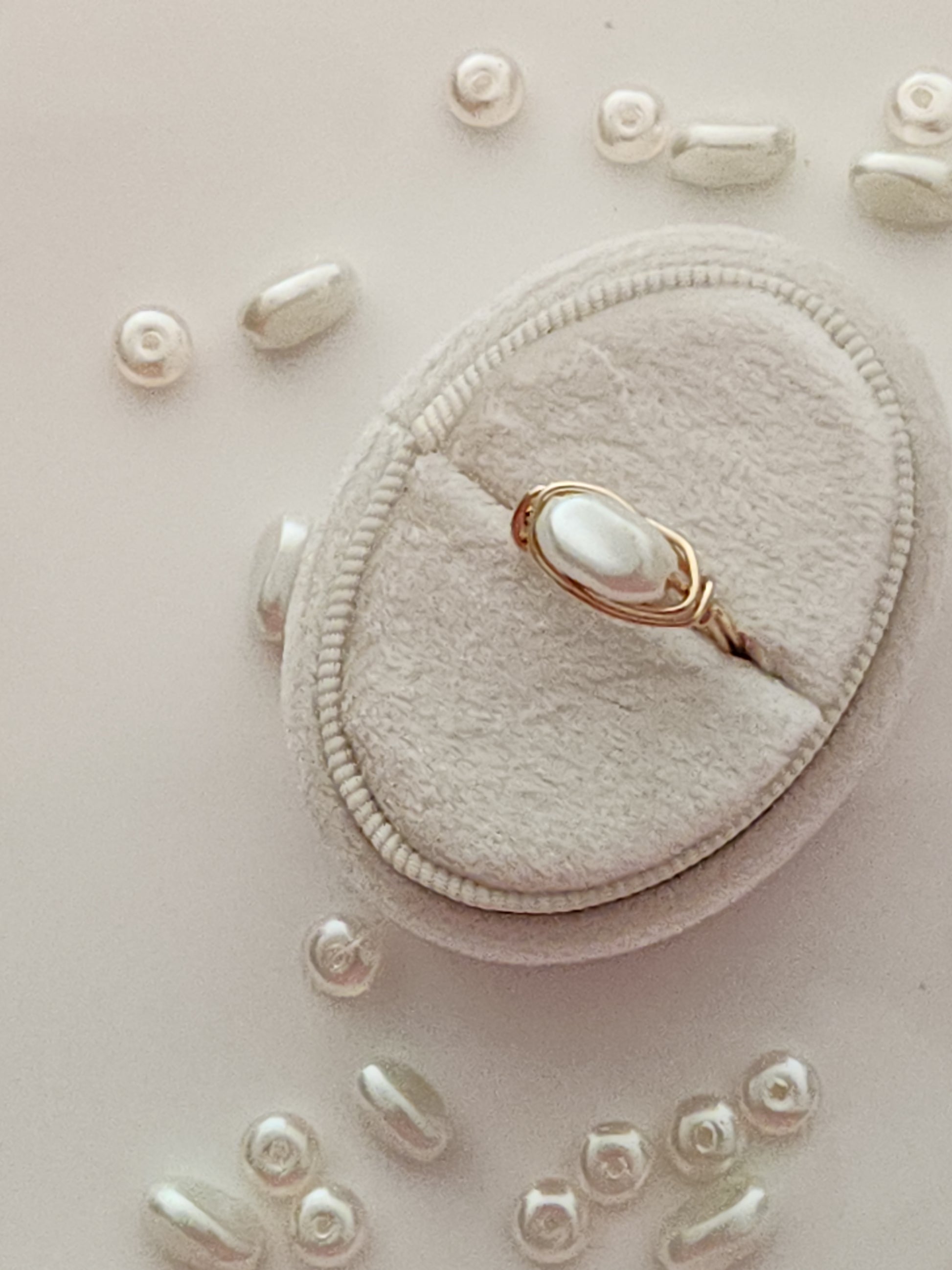 Side view of oblong freshwater pearl ring showing gold-filled wire wrapping detail