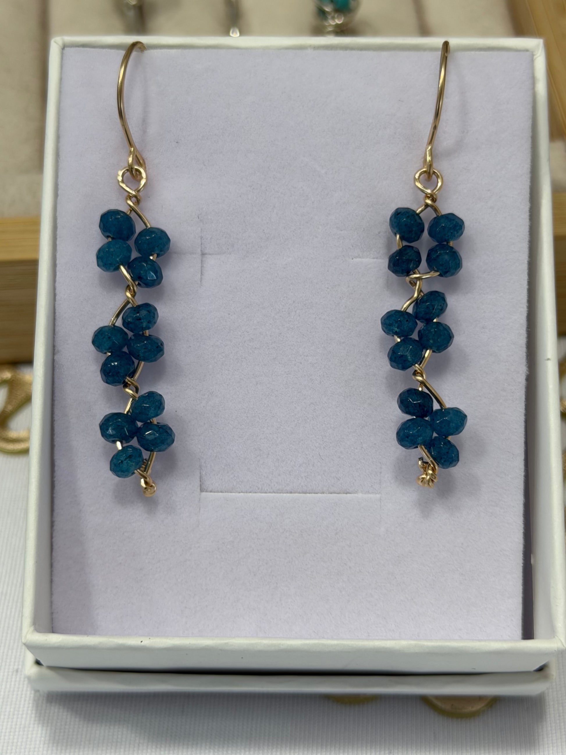 Blue apatite gemstone earrings handcrafted with 14k gold-filled wire for permanent jewelry in Destin, Florida