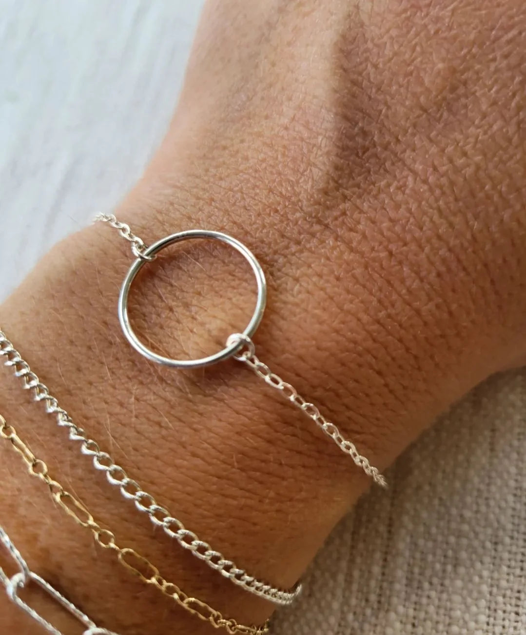 Permanent jewelry gift certificate in Destin and Navarre Florida featuring sterling silver bracelet worn on wrist