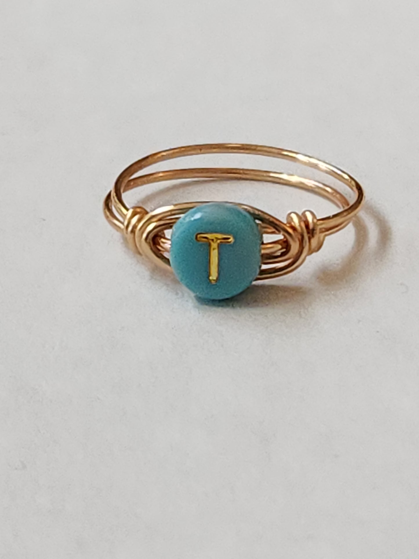 Handcrafted personalized initial ring made with 14k gold-filled wire and turquoise enamel letter charm