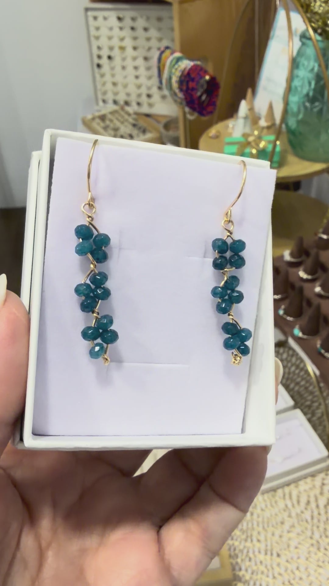 Short video showing blue apatite gemstone earrings made with 14k gold-filled wire, featured in a permanent jewelry collection in Destin, FL