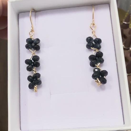 Short video showing black quartz gemstone earrings handcrafted with 14k gold-filled wire, featured in a permanent jewelry collection in Destin, Florida