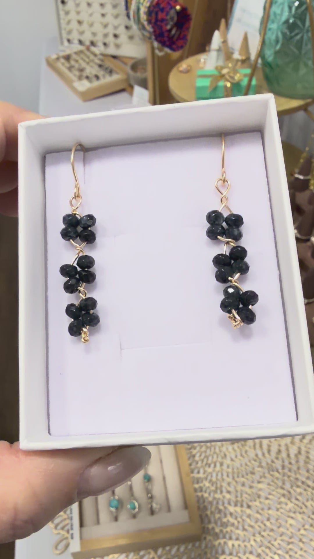Short video showing black quartz gemstone earrings handcrafted with 14k gold-filled wire, featured in a permanent jewelry collection in Destin, Florida