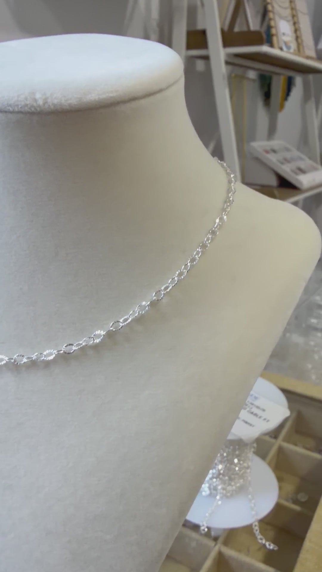 Video showing a sterling silver sunburst chain necklace worn on the neck, highlighting its light-catching texture