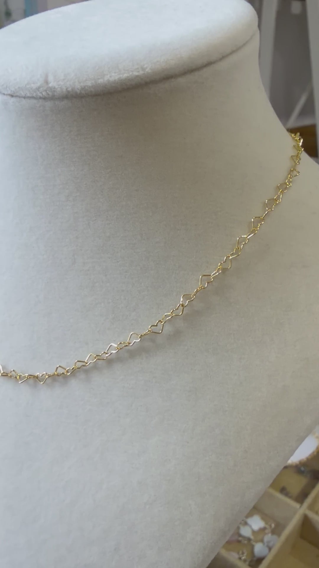 Video showing a 14k gold-filled heart link necklace worn on the neck, highlighting the open-heart chain design