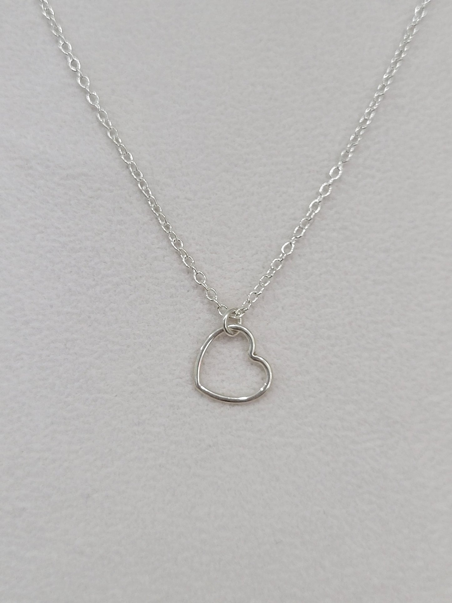 Sterling silver dainty heart necklace with open heart pendant on a delicate silver chain