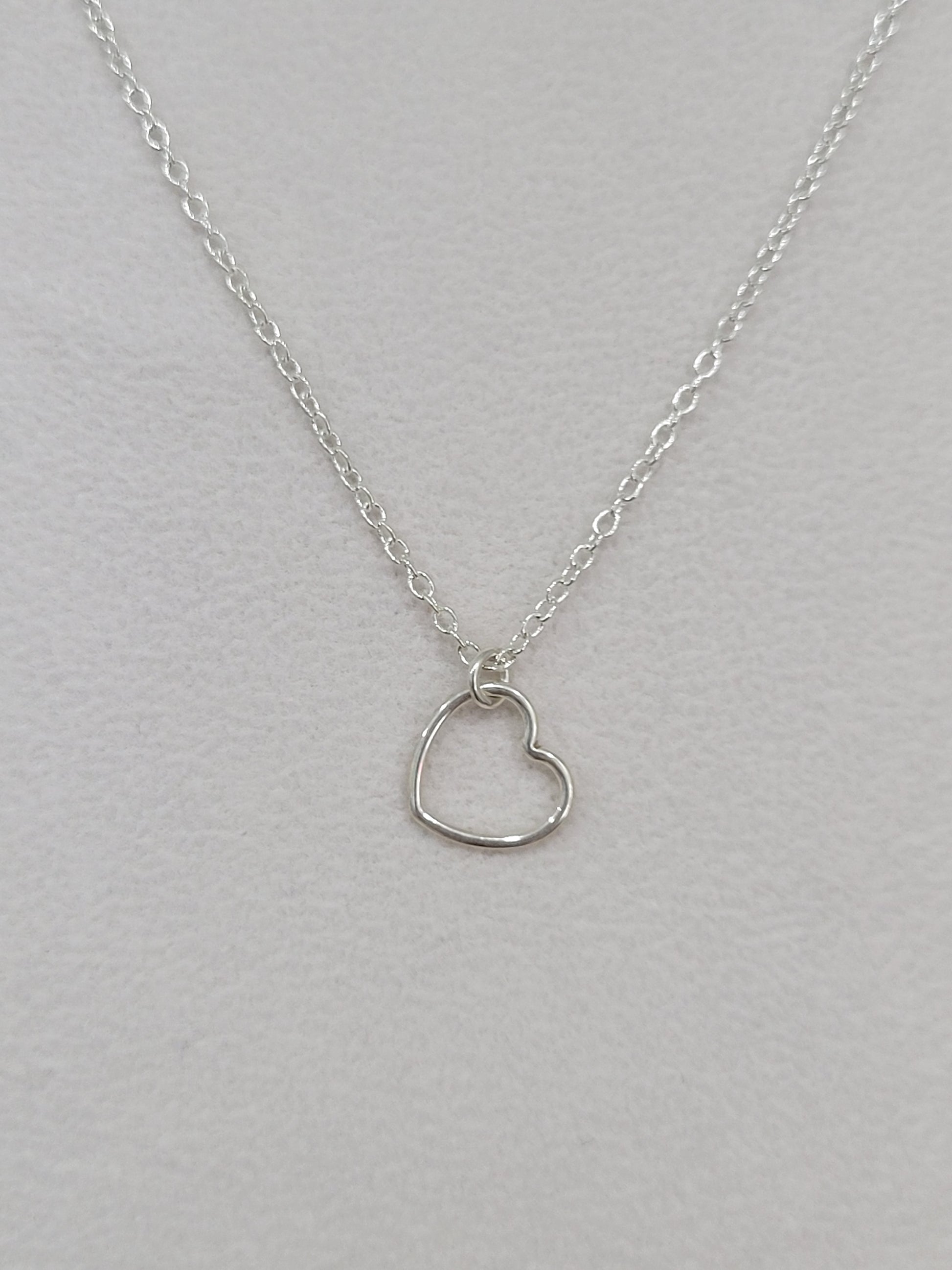 Sterling silver dainty heart necklace with open heart pendant on a delicate silver chain