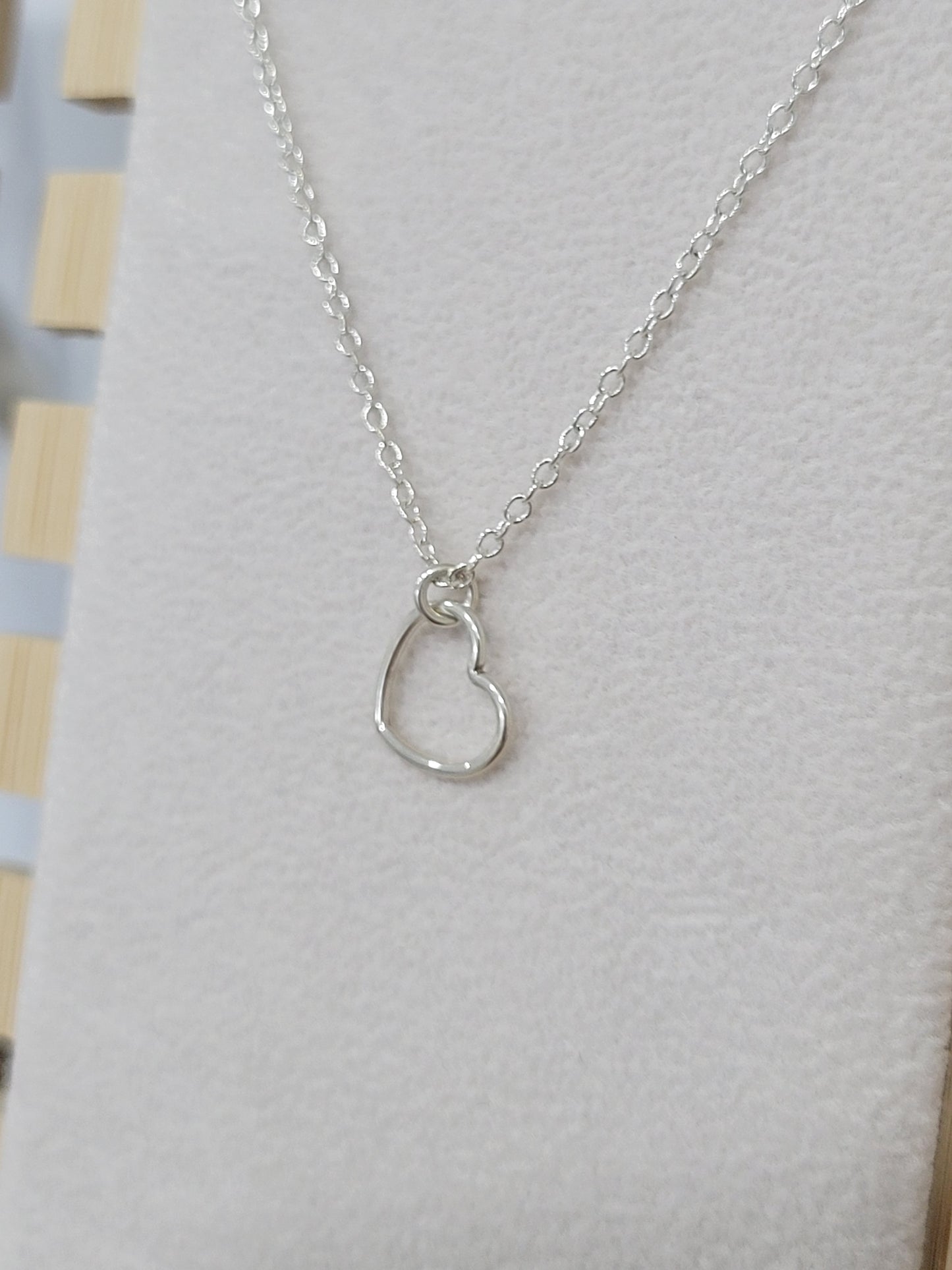 Sterling silver open heart necklace worn on a mannequin, minimalist everyday jewelry