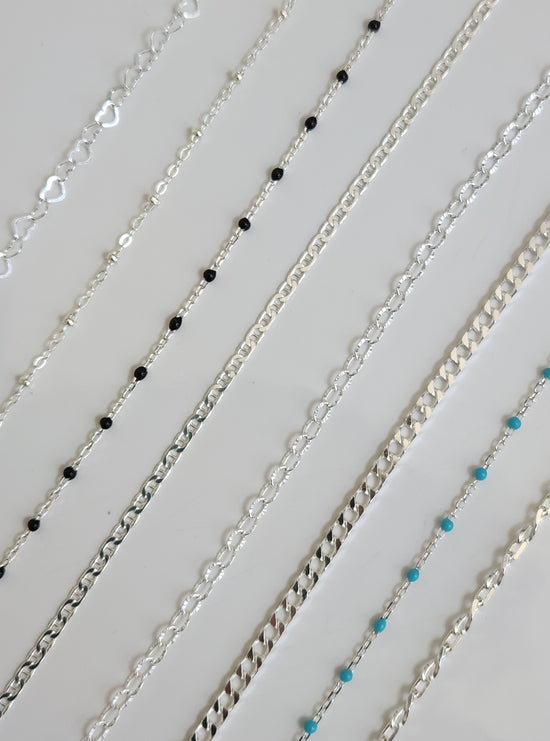 Sterling silver permanent jewelry chains featuring classic and colored sterling styles displayed for customization