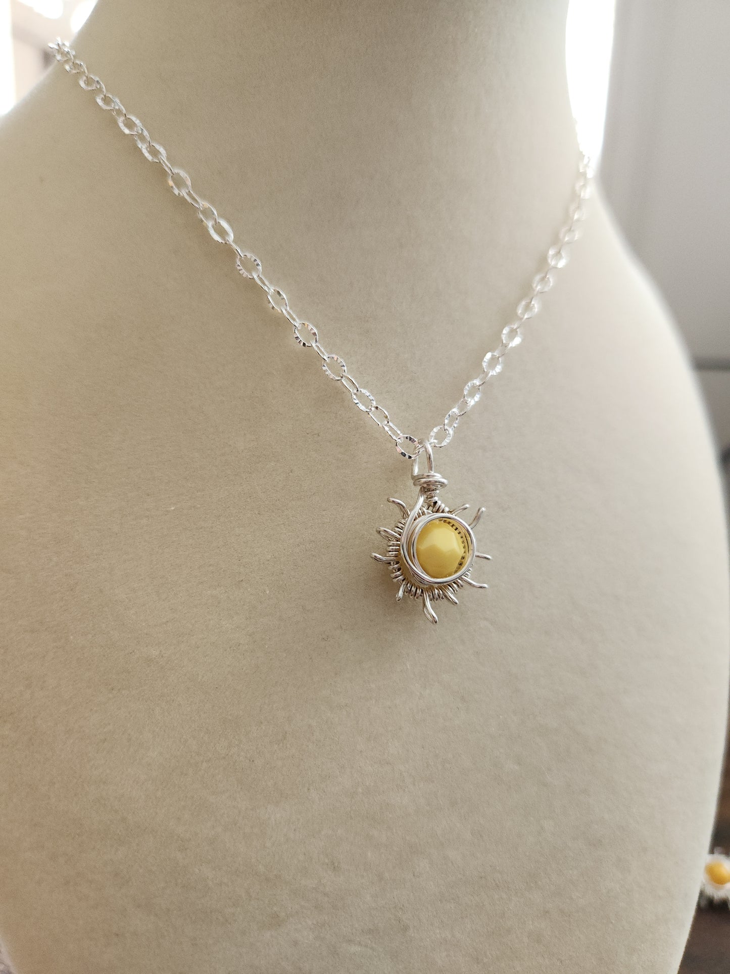 Sterling silver sun necklace with faceted golden gemstone pendant on silver chain