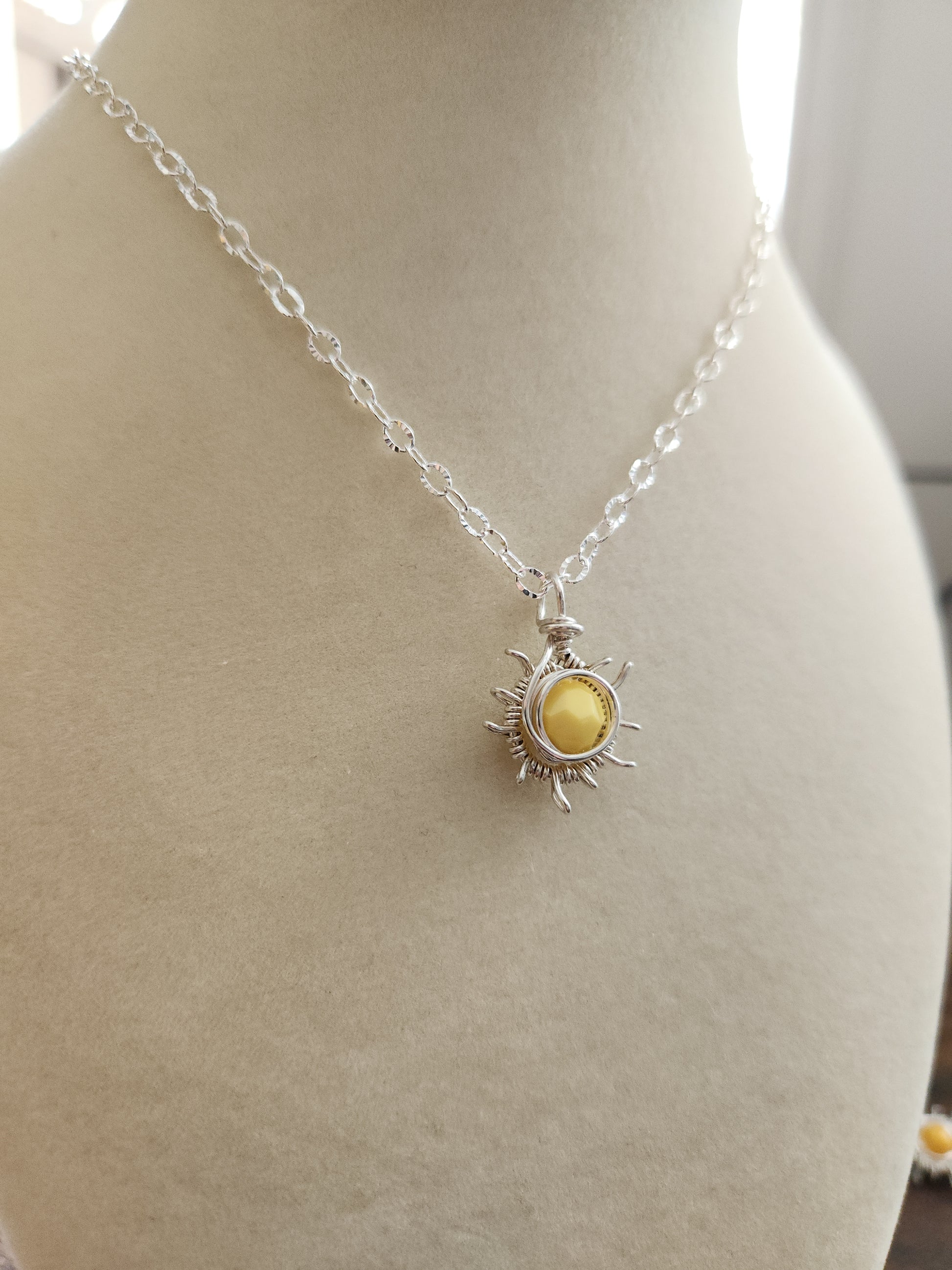 Sterling silver sun necklace with faceted golden gemstone pendant on silver chain