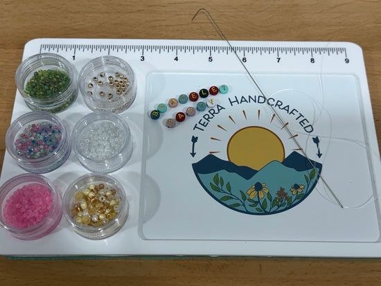 Permanent jewelry charms and connectors displayed at Terra Handcrafted jewelry studio in Destin, Florida, featuring sterling silver and gold-filled charm options