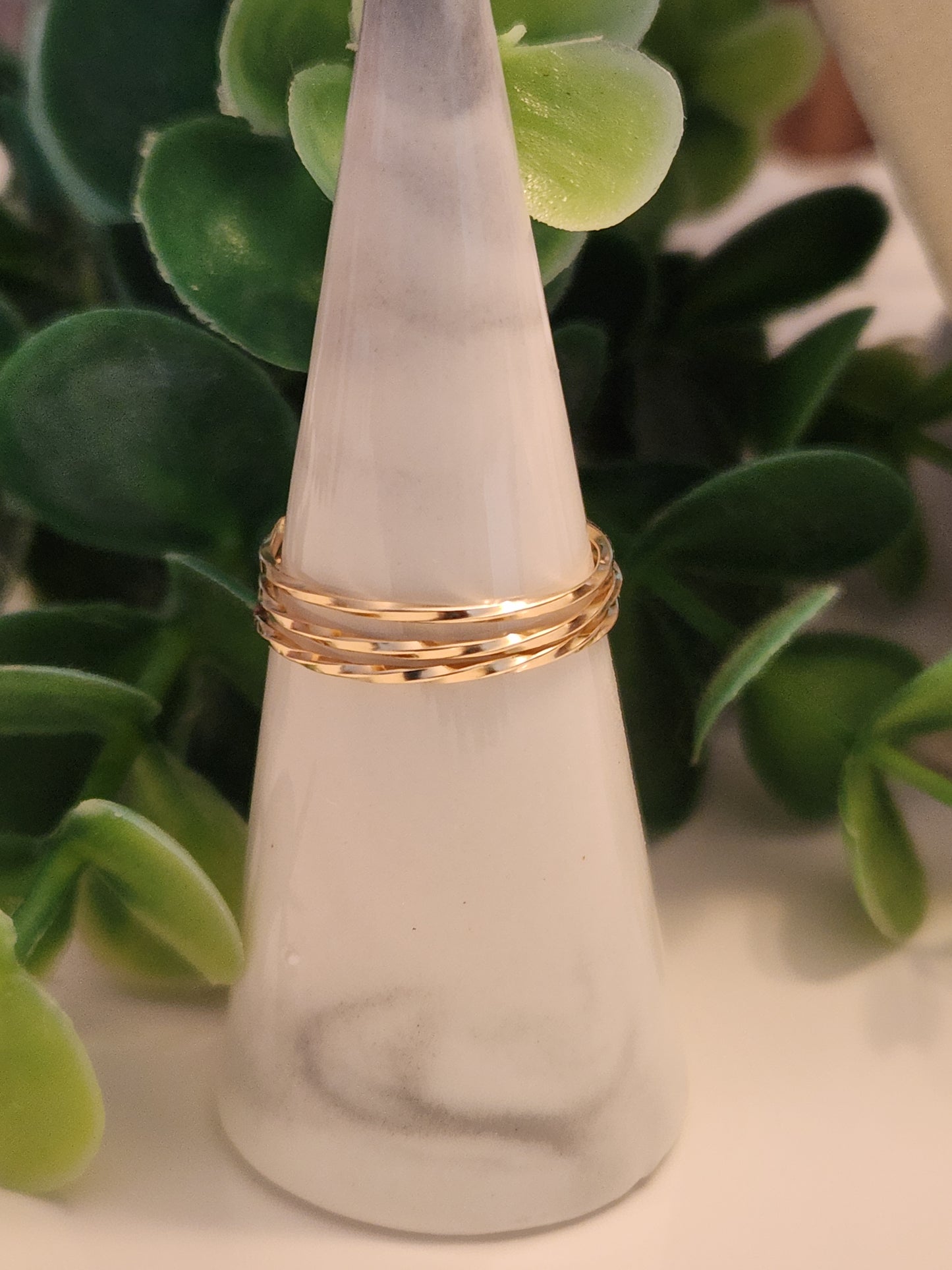 14k gold-filled tide stacking ring with hammered finish displayed on a ring stand