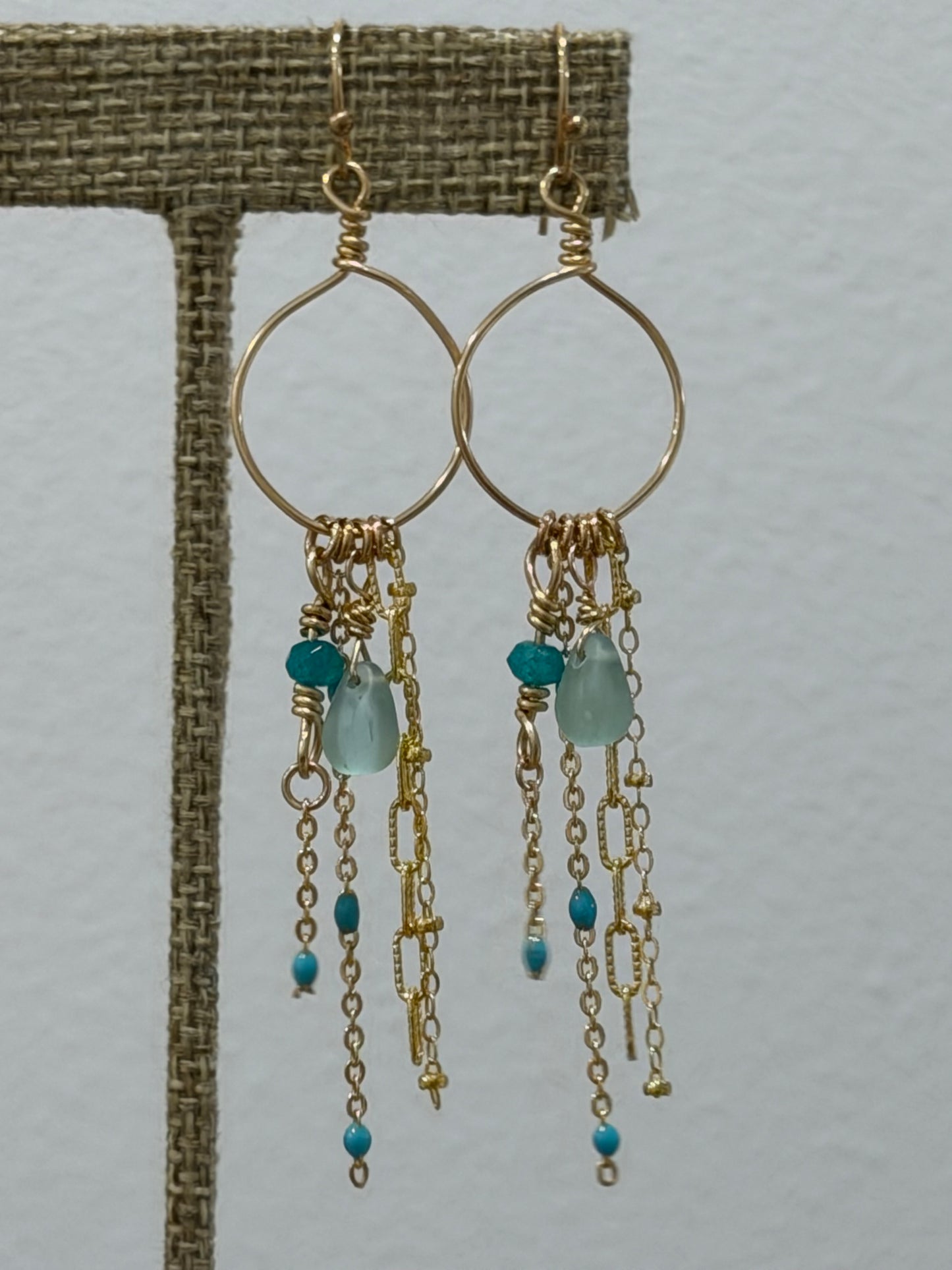 Handcrafted gold-filled Whispering Waves earrings featuring cascading gemstone chains in a coastal design